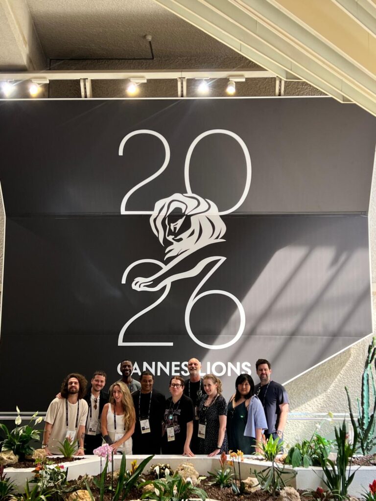 The jurors pose inside the Palais in front of a Cannes Lions sign after deliberations.
